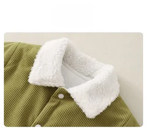 Close-up of green corduroy baby romper with soft white fleece collar and buttons