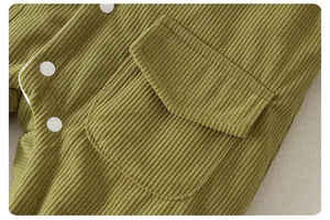 Detail of ribbed olive green baby jumpsuit with white snap buttons and a small flap pocket