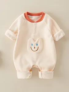 Thick baby fleece romper with cute smile face patch and orange ribbed crew neckline