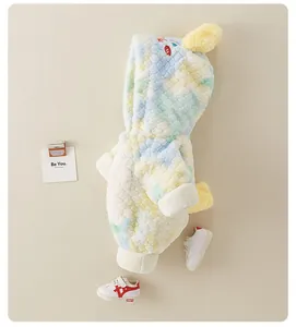Detail view of colorful fuzzy hooded baby romper with soft plush fabric and decorative horns