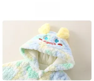 Detail of baby winter romper featuring rainbow plush fur and a monster hood embroidery