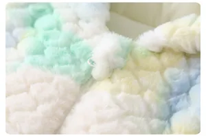 Detail of colorful plush faux fur baby jumpsuit with macaron gradient and soft white zipper