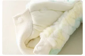 Macro detail of plush faux fur baby romper with ribbed edges and white snap buttons