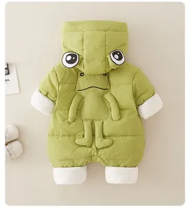 Detail of light green baby frog romper showing 3D eye hood and plush doll ornament