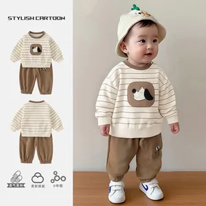 Detail of baby striped sweatshirt and brown pants set with cute cartoon puppy print