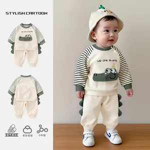 Detail of baby set with breathable fabric, green crocodile patches and soft textures