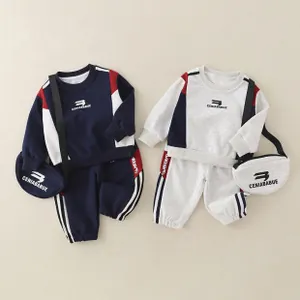 Detail of boys cotton sweatshirt set with matching crossbody bag and stripe patterns