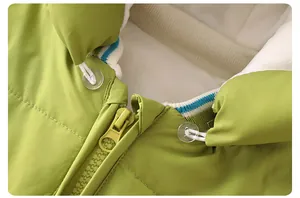 Detail of baby winter jumpsuit featuring grass green fabric and striped knit collar