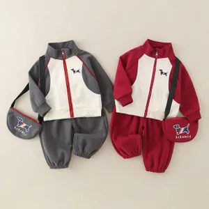 Flat lay of baby boys cotton sport sets with puppy embroidery and zip-up jackets