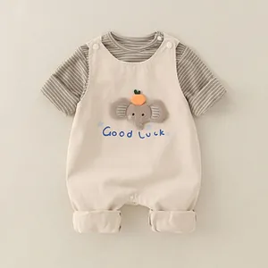 Detail of baby boy cotton striped set featuring cute 3D elephant patch and blue lucky text