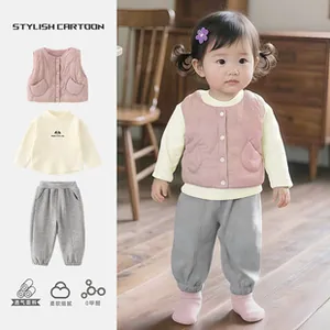 Detail of pink quilted vest with white sweatshirt and gray joggers 3-piece kids winter set