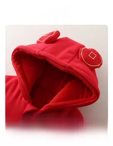 Detail of red baby winter romper hood with golden coin embroidery and warm fabric