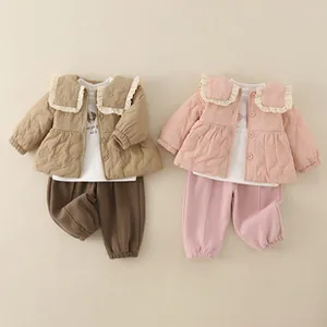 Detail of baby winter 3-piece set featuring quilted jacket with lace collar and pants