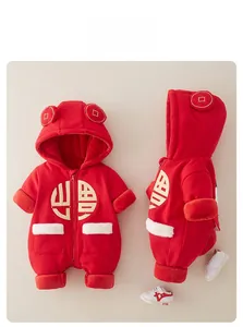 Detail of red baby winter romper featuring golden pattern and white faux fur trim decor