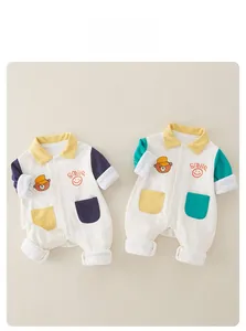 Detail of baby cotton onesies with yellow collars and cute cartoon bear embroidery