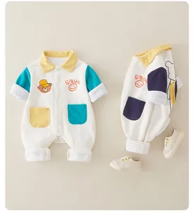 Detail of baby cotton romper featuring cartoon bear print and colorful polo collar pockets