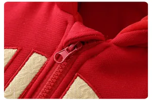 Close-up of red winter baby romper with high-quality zipper and golden embroidery details