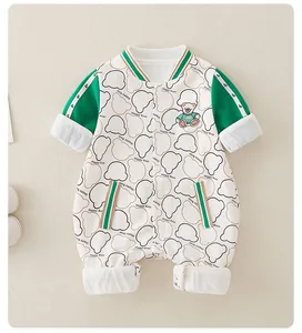 Detail of baby bear onesie showing green striped cuffs and Happy Bear embroidery print