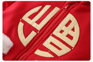 Detailed view of red baby winter jumpsuit with gold embroidery and faux fur trim