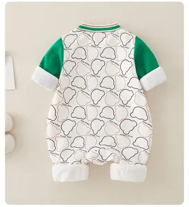 Detail of baby bear print romper with green sleeves and soft faux fur trim cuffs