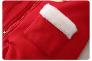 Detailed close-up of red winter baby romper with white faux fur pocket and zipper