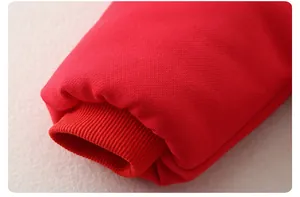Detailed macro view of the festive red ribbed cuffs on this thick winter baby romper