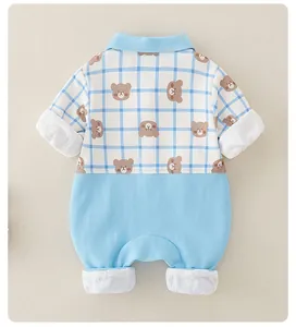Detail of baby romper featuring blue plaid pattern and cute cartoon bear print design