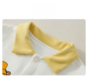 Detail showing the yellow ribbed polo collar and soft cotton texture of baby bodysuit