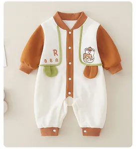 Detailed close-up of waffle knit fabric and cute bear embroidery on baby romper