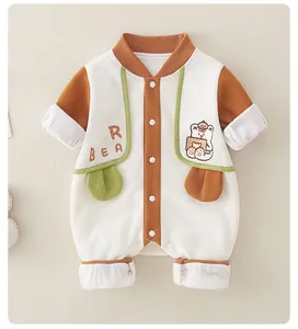 Detailed view of baby bear romper in cream waffle knit with brown contrast piping