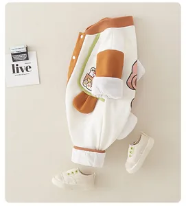 Detail of baby cotton waffle romper with rabbit pattern and contrast sleeve stitching