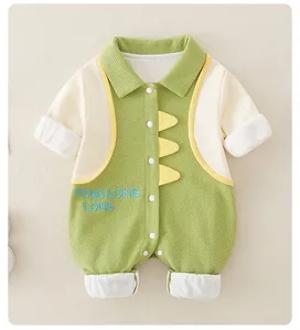 Close-up of green cotton baby romper with dinosaur embroidery and snap button closure