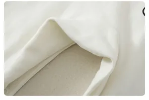 Macro detail of soft cotton knit fabric with warm fleece lining and resin button