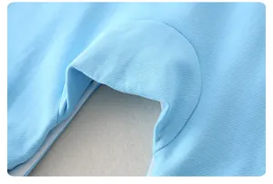 Close-up of light blue knitted fabric texture and fine stitching on a baby bodysuit