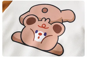 Close-up of white waffle texture cotton with a cute brown bear cartoon print detail