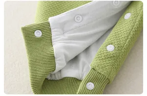 Detailed macro view of light green waffle knit cotton fabric with white snap buttons