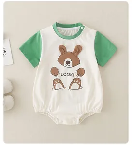 Detailed view of baby bodysuit with bear embroidery and snap buttons on soft cotton