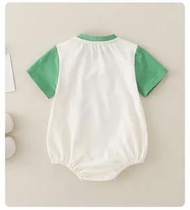 Detail of baby short sleeve bodysuit in white and green cotton with elastic leg openings