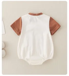 Flat lay detail of a short-sleeve cotton baby bodysuit with brown contrast collar