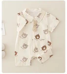 Close-up of baby cotton romper featuring bear prints, a small collar, and snap buttons