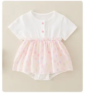 Detail view of pink balloon print skirt and snap buttons on baby cotton romper dress