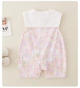Detail of baby girl cotton summer romper featuring white collar and purple floral print