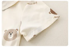 Close-up of baby romper fabric showing cute bear print and soft cotton texture
