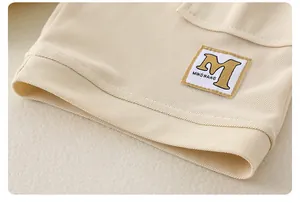 Detalle macro de tela de algodón beige con etiqueta cuadrada de MINGWANG cosida