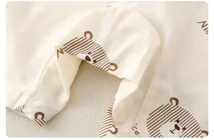 Close-up of soft cotton baby romper fabric with cute bear print and Nice lettering