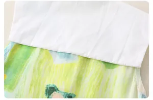 Detail of baby cotton romper white collar and green watercolor print stitching