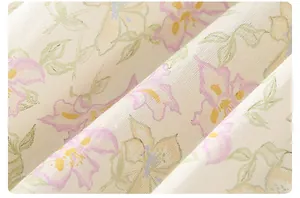 Close-up of baby romper fabric with delicate floral patterns and soft cotton texture