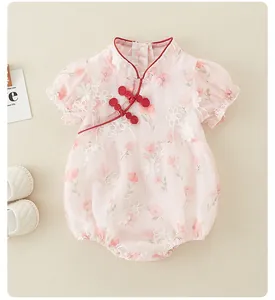 Detail of pink baby bodysuit with Chinese knot buttons and exquisite floral lace embroidery