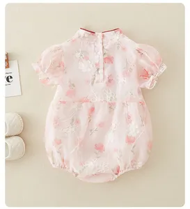 Close-up of pink floral baby romper with Chinese collar and puff sleeves detail