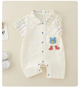 Detail of cotton baby romper featuring a polo collar and cute blue bear patch